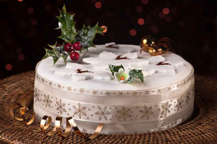 Christmas cake with fondant icing, fondant stars and holly sprig