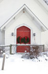 Red Church door with wreaths